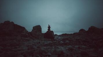 CGI Sunset silhouette of a person balancing rocks on a calm shore video