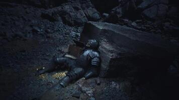 CGI Dead knight resting against a stone in a dimly lit cave setting video