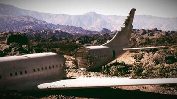 CGI Plane wreckage rests in rocky terrain surrounded by mountains video