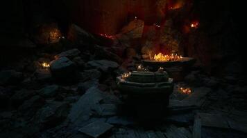 CGI Mysterious underground cavern with flickering candles illuminating stone altar video