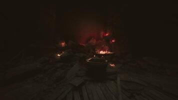 CGI Mysterious cave interior with glowing rocks and flickering flames at night video