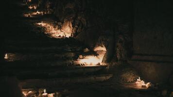 CGI Flickering candle lights illuminate stone steps in a dark setting video