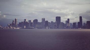CGI City skyline under a cloudy sky viewed from the water in late afternoon light video