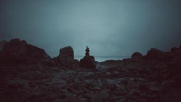 CGI Calm seaside evening with rock stack against dark moody backdrop video
