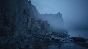 CGI Misty cliffs at dusk along a rocky coastline by the sea video