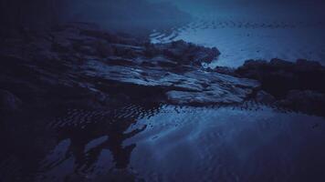 CGI Misty water surface reflecting stones at twilight near a tranquil shoreline video