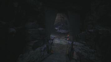 CGI Mysterious cave entrance surrounded by shadows and rocks at dusk video