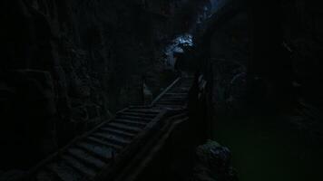 CGI Dark, mysterious staircase leading into a cave with faint light above video