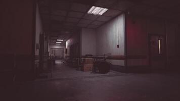 CGI Dimly lit hospital corridor with empty equipment and scattered boxes at night video