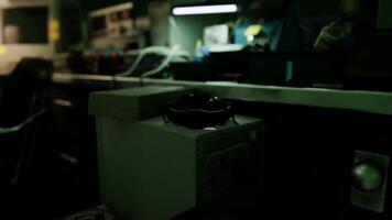 CGI A pair of glasses rests on a desk in a dimly lit workspace at night video