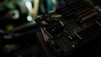 CGI Detailed close up of a circuit board with fan in a tech workshop environment video