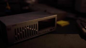 CGI A vintage audio receiver on a dark surface in a dimly lit room video