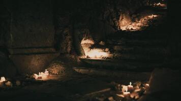 CGI Mysterious candlelit pathway in a dark, ancient cavern at night video