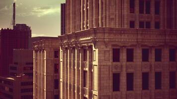 CGI Golden hour light casts a warm glow on urban architecture in the city video