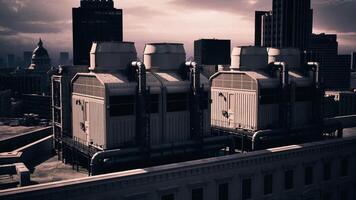 CGI Industrial cooling towers rise above a city skyline under a cloudy evening sky video