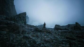 CGI Serene rock formation on a foggy shore during twilight hours video