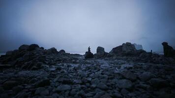 CGI Rock formation at twilight near a coastal area with a misty atmosphere video