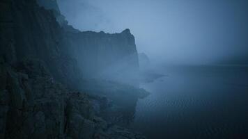 CGI Mysterious coastline shrouded in fog during twilight hours video