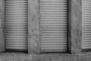 Shuttered windows reveal the texture and patterns of a building in an urban setting during the afternoon photo