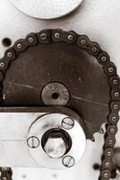 Gears and chains interact in a mechanical dance in an industrial workshop photo
