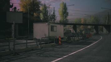 CGI Quiet road under a bridge with construction barriers and trailers in rural area video