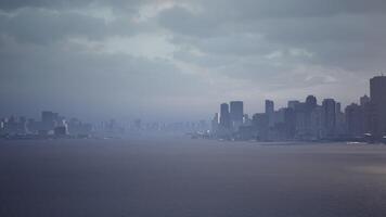 CGI City skyline view under a cloudy sky over calm waters at dusk video