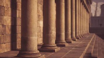 CGI Classic architectural columns lined along a stone structure in warm sunlight video