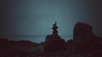 CGI Stacked stones at dusk near ocean creating a tranquil ambiance video