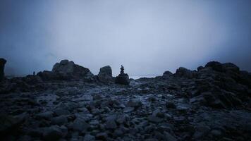 CGI Dark coastal landscape with rock formations and a solitary figure on the shore video