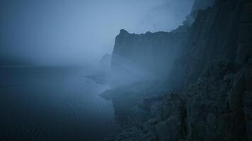 CGI Foggy coastline at dusk with dramatic cliffs and tranquil water video