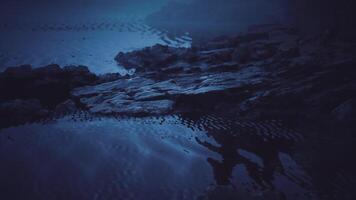 CGI Tranquil water reflection at dusk near rocky shore video