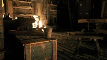 CGI Warm glow from a fireplace illuminates a rustic workshop at night video
