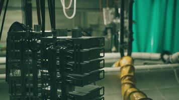 CGI Industrial equipment setup in a dimly lit space with pipes and cables video
