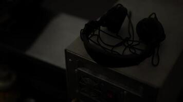 CGI Vintage headset on a desk in a dim room, creating nostalgia video