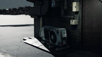 CGI Old air conditioning unit by a building on a quiet street at dusk video