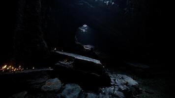 CGI Exploring a dark cave with faint natural light filtering through video