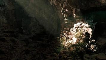 CGI Light beams filter through a cave entrance illuminating rocky surroundings video