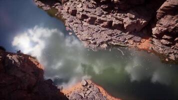 CGI Colorado River flowing through rugged canyon walls under a cloudy sky video