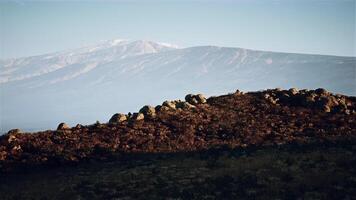 CGI Distant mountain range viewed from rocky hillside during late afternoon light video