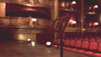 CGI An old opera house with a music stand and empty red velvet chairs video