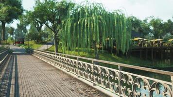 CGI A serene walkway with lush greenery beside a tranquil waterway during daylight video