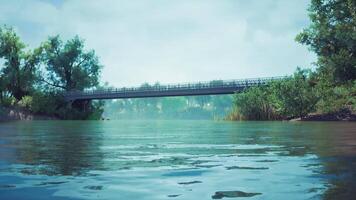 CGI Calm river with a bridge under a blue sky in a serene natural landscape video