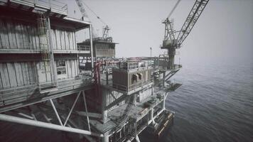CGI Old oil platform located offshore with cranes in the background and calm water video