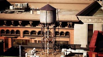 CGI Historic water tower on a rooftop in a bustling urban setting during daylight video