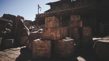 CGI Wood crates stacked outside a weathered building in a desert town at dusk video