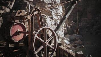 CGI Old mining equipment at a remote location in the mountains during daylight video