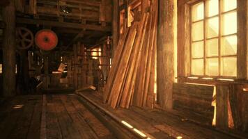CGI Warm sunlight filters through wooden beams in an old workshop at sunset video