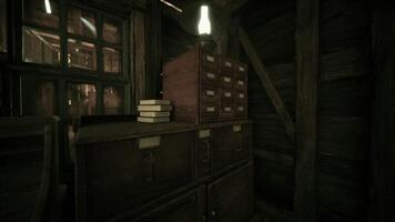 CGI Rustic wooden furniture with a lamp and books in a dimly lit cabin video