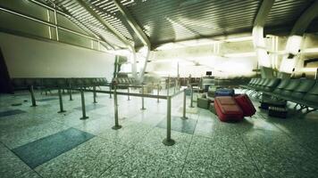 CGI Abandoned airport terminal with scattered luggage and empty seating in daylight video