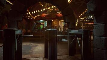 CGI An empty amusement park stands silent at night, illuminated by colorful lights video